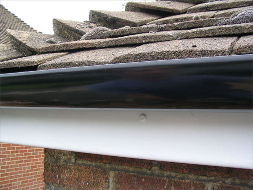 Popular choice standard black high gloss guttering fitted to maintenance free white upvc fascias.